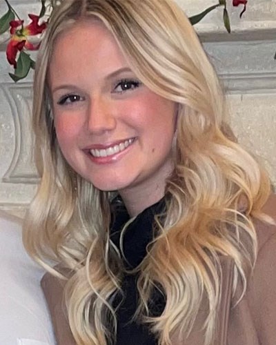 Anna is shown smiling for the camera.